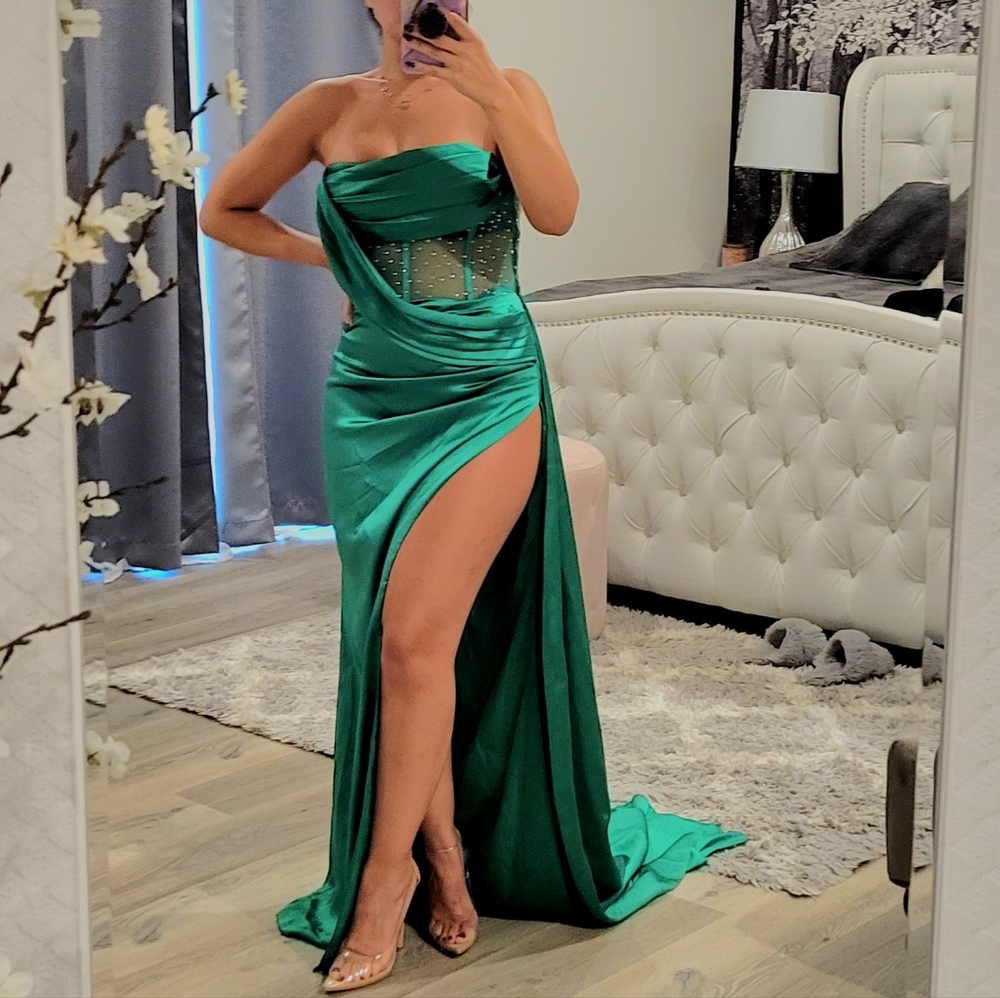 Green evening strapless dress with a slit on one side. Size small.